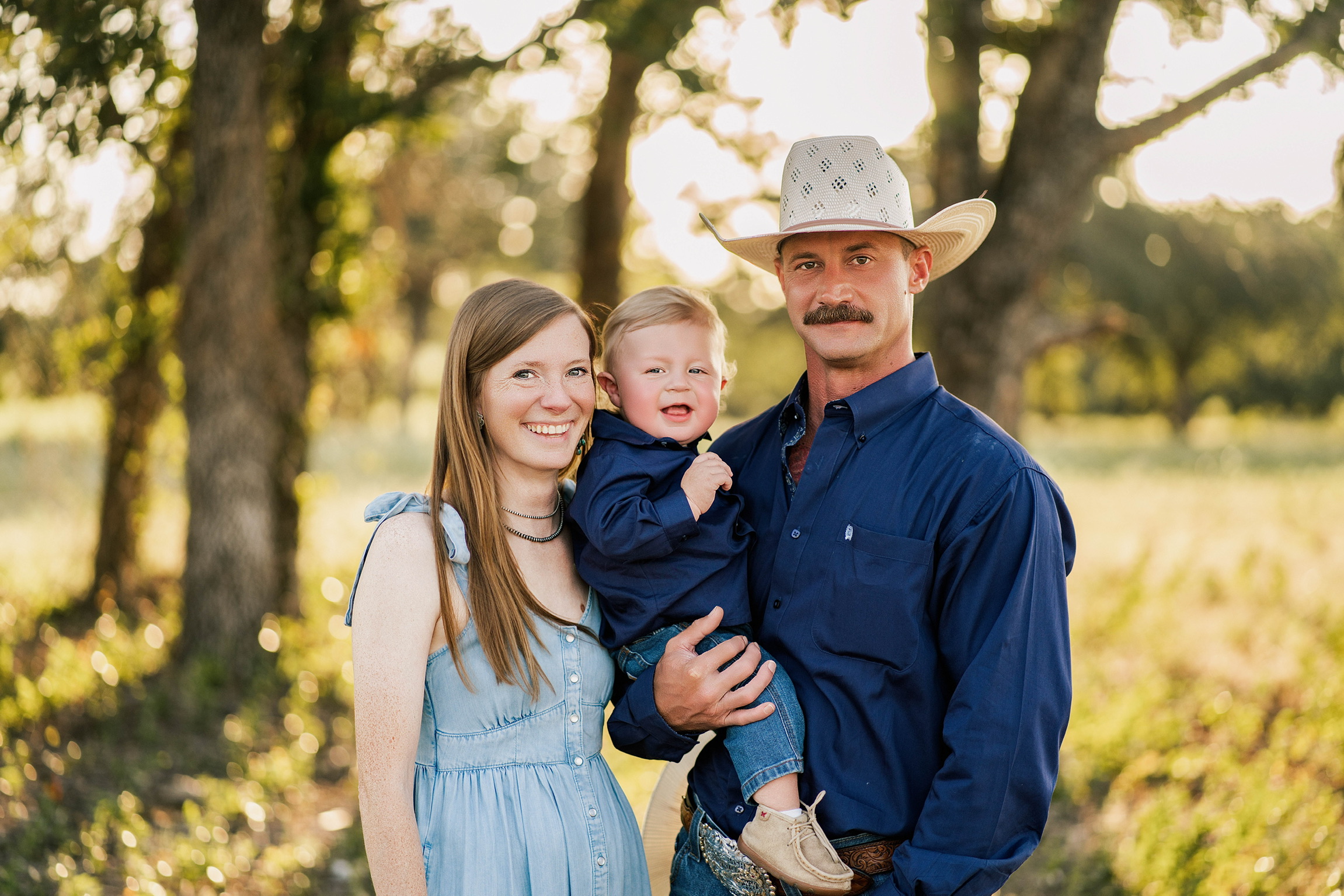 Jeremy and Lauren Hopkins with their son Jameson outdoors